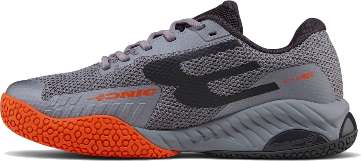 Bullpadel Ionic 26I Mens Padel Shoes - Dark Grey feature an orange sole, black and orange accents, mesh upper, and laces—ideal for intermediate to advanced players wanting top performance and style.