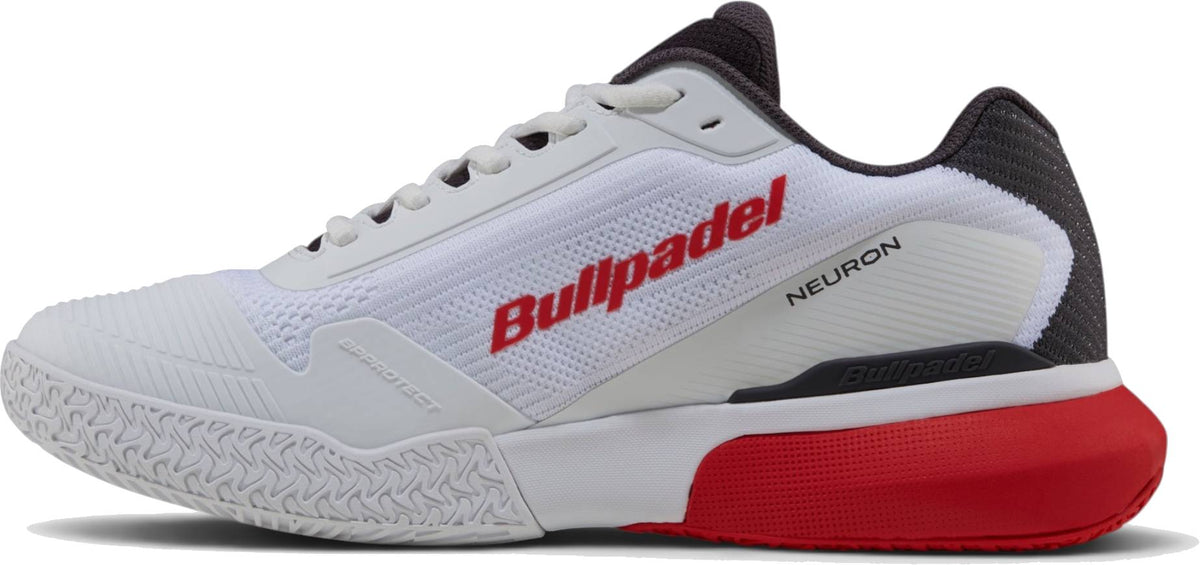 A white athletic shoe with black and red accents, Bullpadel Neuron 26I Mens Padel Shoes - White features a textured sole and bold Bullpadel branding—ideal for Fede Chingotto fans.