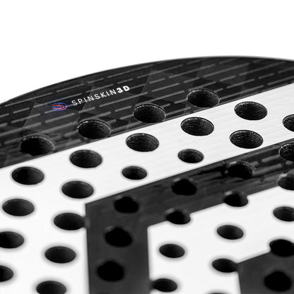 Close-up of the Tecnifibre Curva Power Padel Racket - Black, showcasing circular holes and an 18K carbon face with a textured look featuring "SPINSKIN3D" branding.