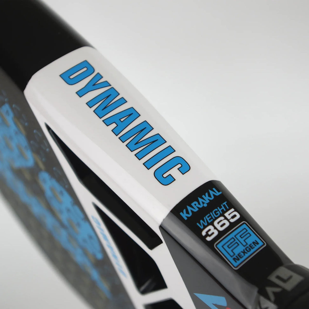 Close-up of a Karakal Chaos Dynamic 2026 padel racket frame showing “DYNAMIC” in blue text on a white bridge, with specifications reading “WEIGHT 365” and “FF NEXGEN” printed on the side.