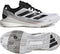 Cloud White, Core Black, and Silver Metallic adidas Crazyquick Boost Men's Padel Shoes are shown from the side and bottom, highlighting their signature three black stripes, textured sole, and mixed synthetic materials designed for running or sports activities. These adidas Crazyquick Boost men's padel shoes provide enhanced energy return to keep you performing efficiently on the court.