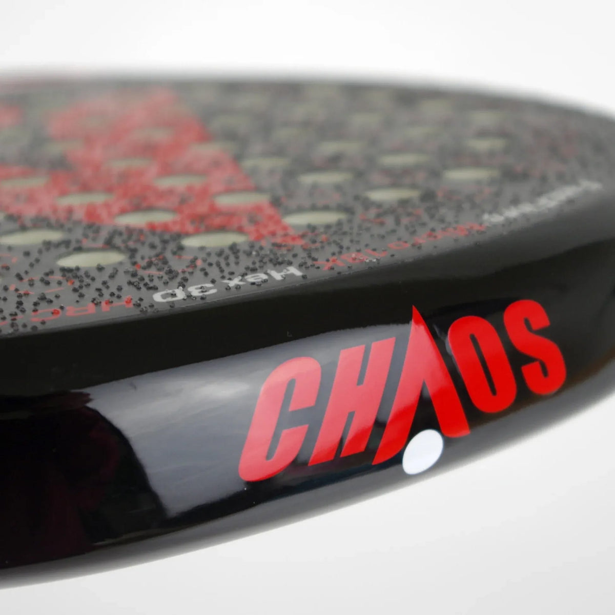 Close-up of a Karakal Chaos Shredder 2026 padel racket edge featuring “CHAOS” in red text on a black glossy frame.
