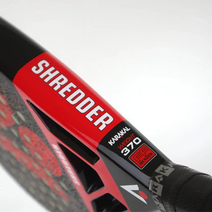 Close-up of an 18K carbon graphite Karakal Chaos Shredder 2026 padel racket, featuring a black and red frame with “SHREDDER,” “WEIGHT 370,” and “FF NEXGEN” printed on the bridge.
