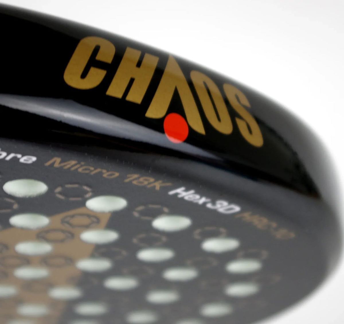 Close-up of a black Karakal Chaos Ultimate 2026 padel racket face, featuring the word “CHAOS” in gold lettering and a pattern of circular holes.