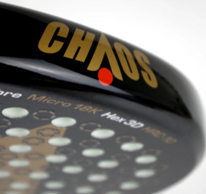Close-up of a black Karakal Chaos Ultimate 2026 padel racket face, featuring the word “CHAOS” in gold lettering and a pattern of circular holes.