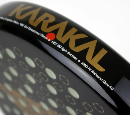 Close-up of the rim of a black Karakal Chaos Ultimate 2026 padel racket, featuring gold text and 18K Carbon Graphite technical specifications.