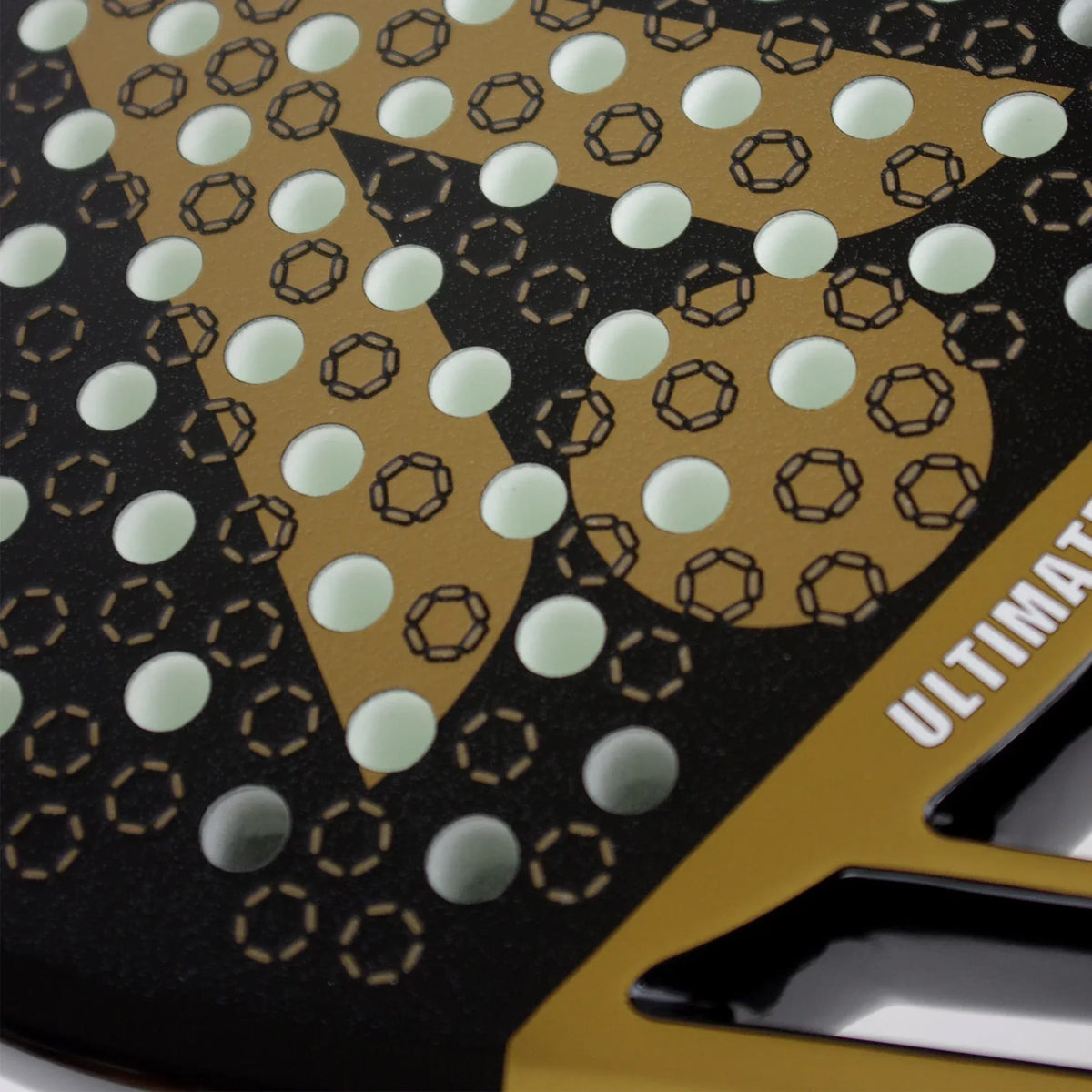 Close-up of a black and gold Karakal Chaos Ultimate 2026 Padel Racket face with a circular hole pattern and the word “ULTIMATE” printed on the edge.