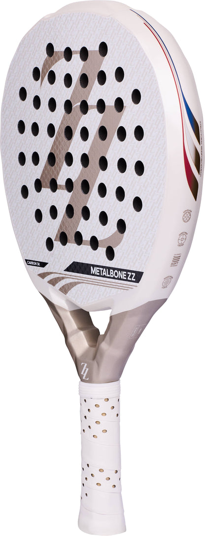 White ADIDAS Metalbone ZZ Carbon Zinedine Zidane 2026 padel racket with a diamond-shaped head, circular perforations, and a silver handle featuring a ZZ logo.