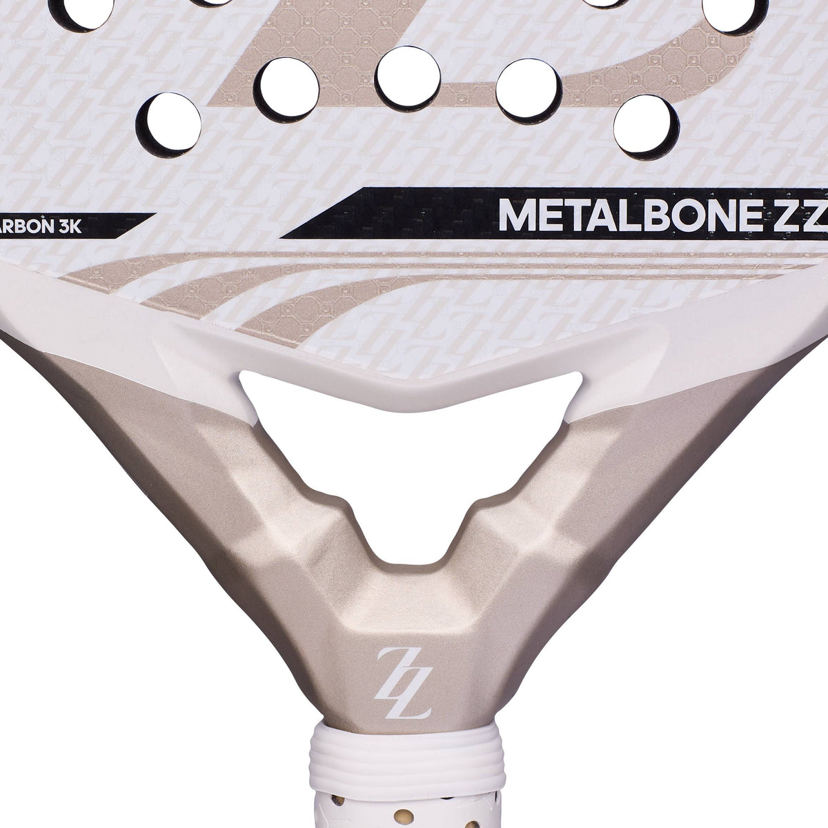 Close-up of a white and gold ADIDAS Metalbone ZZ Carbon Zinedine Zidane 2026 Padel Racket with circular perforations, featuring the text “METALBONE ZZ” and a logo with two Zs on the throat.