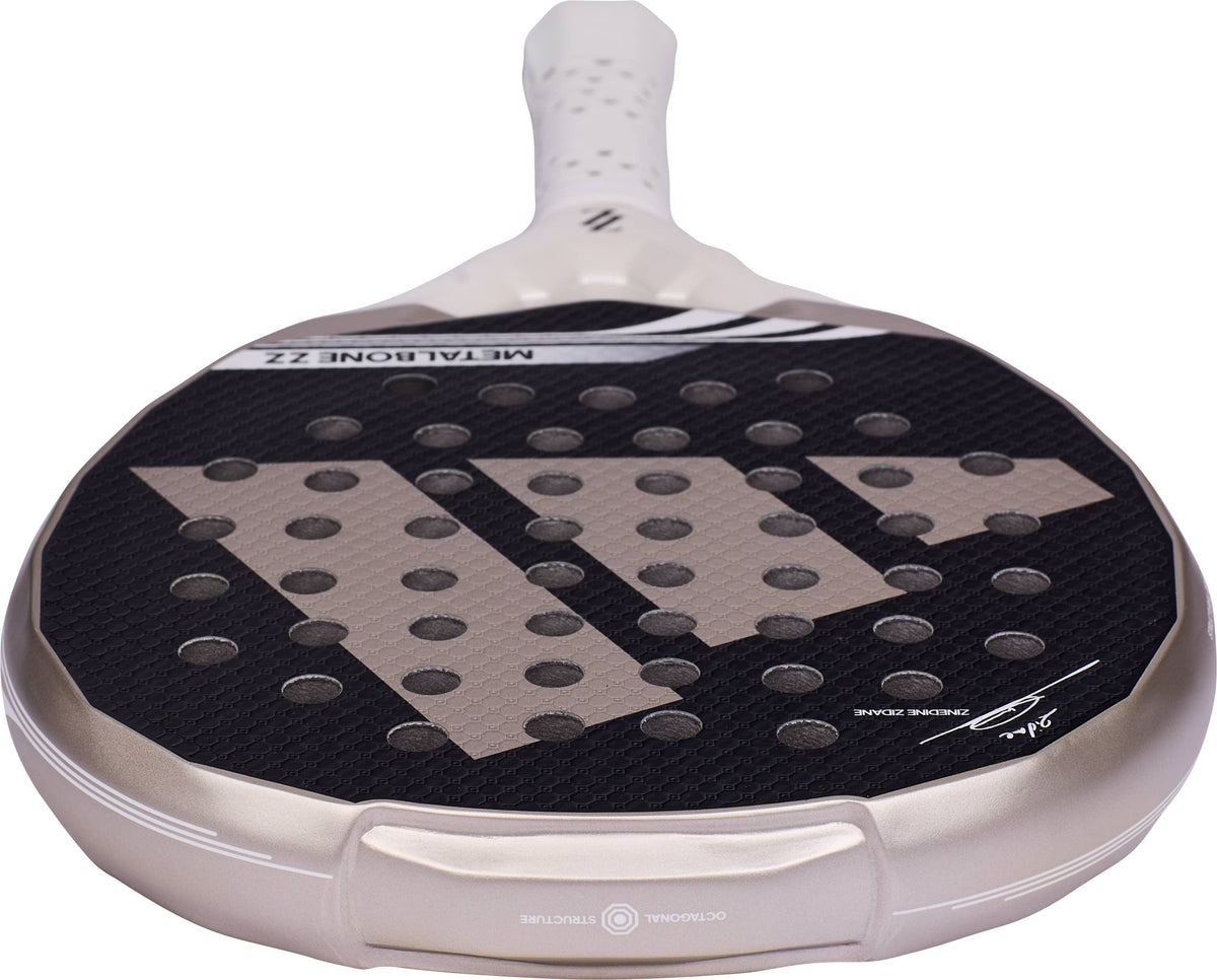 ADIDAS Metalbone ZZ Team Zinedine Zidane 2026 Padel Racket featuring a light gold frame, black perforated hitting surface, and a three-stripe logo design.