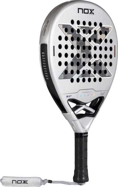 NOX AT10 Genius 12K Alum Xtrem By Agustín Tapia 2027 padel racket with a teardrop-shaped head, featuring a black X pattern over a perforated surface, a black handle, and a matching wrist strap.