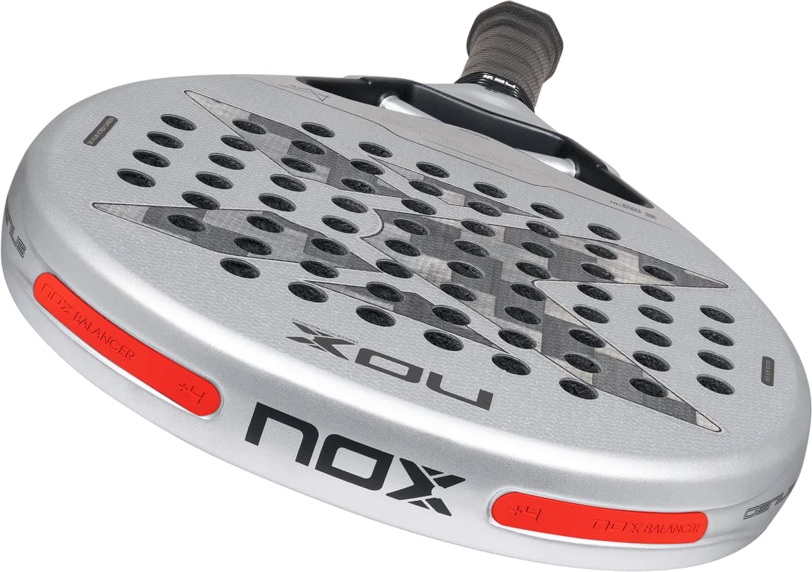 Silver NOX AT10 Genius 12K Alum Xtrem By Agustín Tapia 2027 padel racket with a teardrop head, a black grip, and two red balance weight inserts on the frame.
