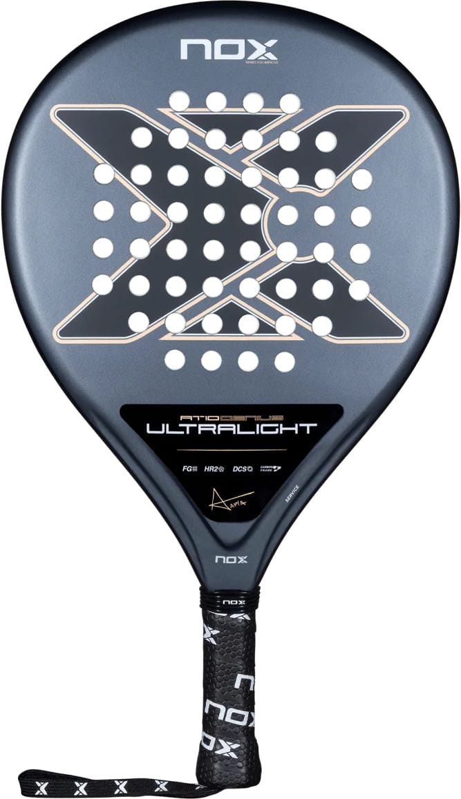 A teardrop-shaped NOX AT10 Genius Ultra Light By Agustín Tapia 2026 padel racket featuring a dark grey surface, a central X-pattern of holes, and a black handle with a wrist strap.