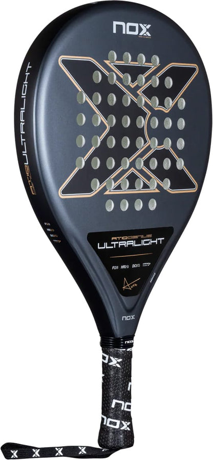 Black NOX AT10 Genius Ultra Light By Agustín Tapia 2026 padel racket featuring a large “X” design, a perforated surface, and the text “AT10 GENIUS ULTRALIGHT” near the handle.