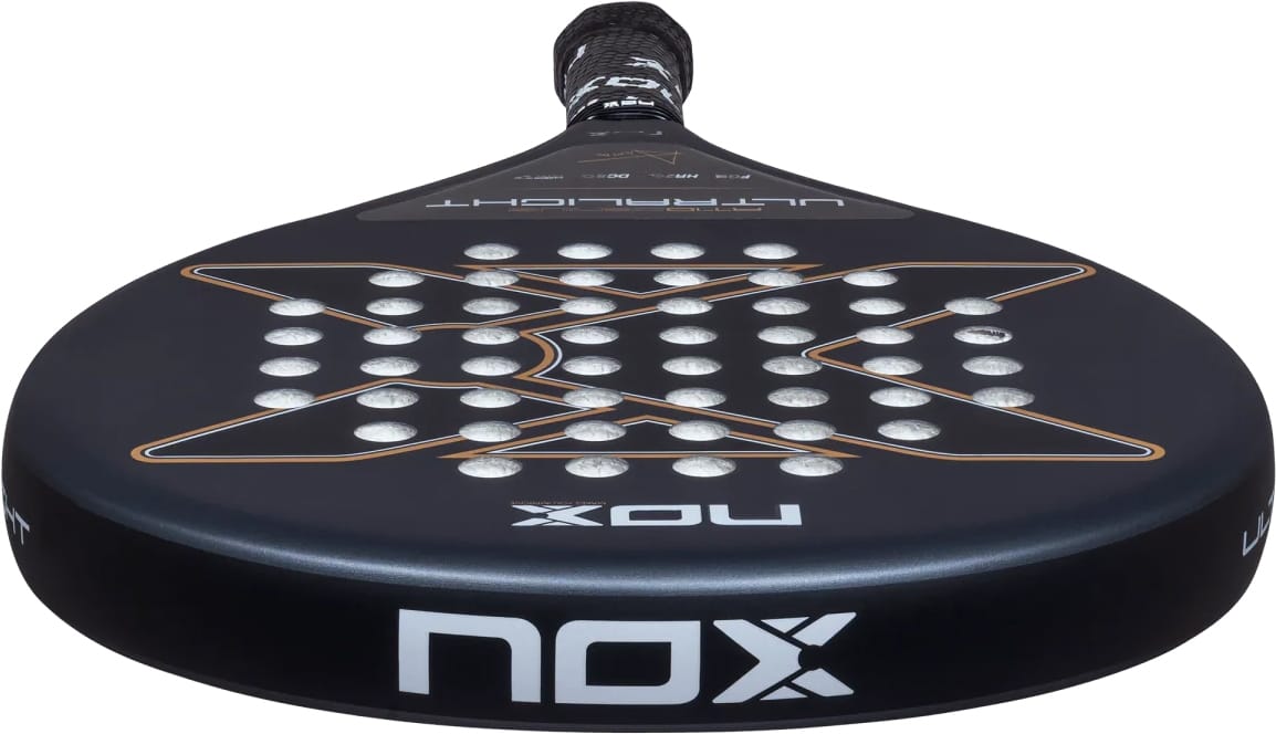 NOX AT10 Genius Ultra Light By Agustín Tapia 2026 padel racket in black, featuring a circular hole pattern, bronze graphic accents, and white logo text on the frame.