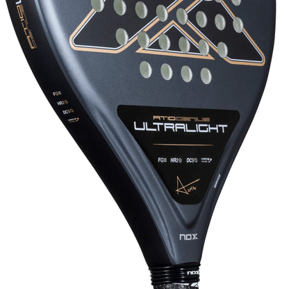 Close-up of a NOX AT10 Genius Ultra Light By Agustín Tapia 2026 padel racket with a perforated surface, featuring branding and a signature printed on the frame.