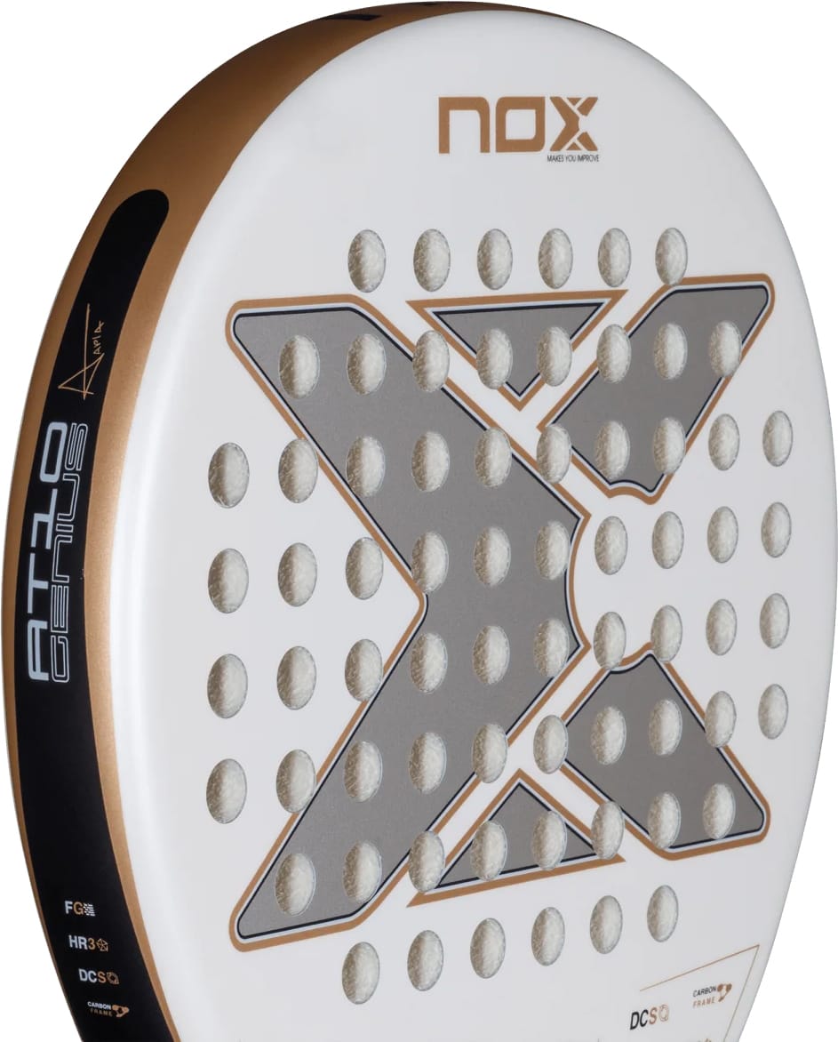 White and gold NOX AT10 Genius Junior 2026 padel racket featuring a large, central X-shaped graphic and a grid of circular holes.