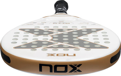NOX AT10 Genius Junior 2026 padel racket in white and gold, featuring a centered dark grey X-shaped pattern with circular perforations.