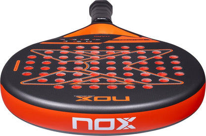 NOX Equation Hard Advanced 2027 padel racket featuring a black design with an orange frame and a pattern of orange circular holes across the 3K fibreglass face.