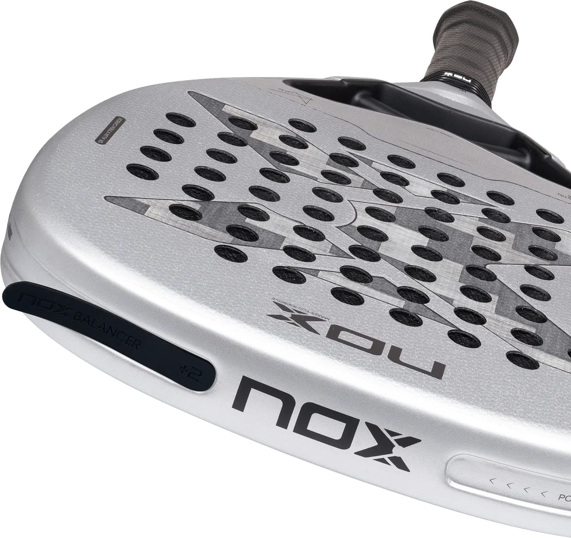 Silver diamond-shaped NOX AT10 Genius Attack 12K Alum Xtrem By Agustín Tapia 2027 padel racket with a perforated surface, black grip, and a balance weight attached to the frame.