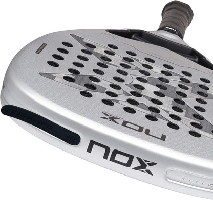 Silver diamond-shaped NOX AT10 Genius Attack 12K Alum Xtrem By Agustín Tapia 2027 padel racket with a perforated surface, black grip, and a balance weight attached to the frame.