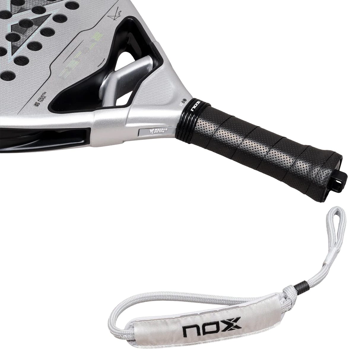 Silver NOX AT10 Genius Attack 12K Alum Xtrem By Agustín Tapia 2027 padel racket with a black perforated grip and a gray wrist strap featuring a logo.