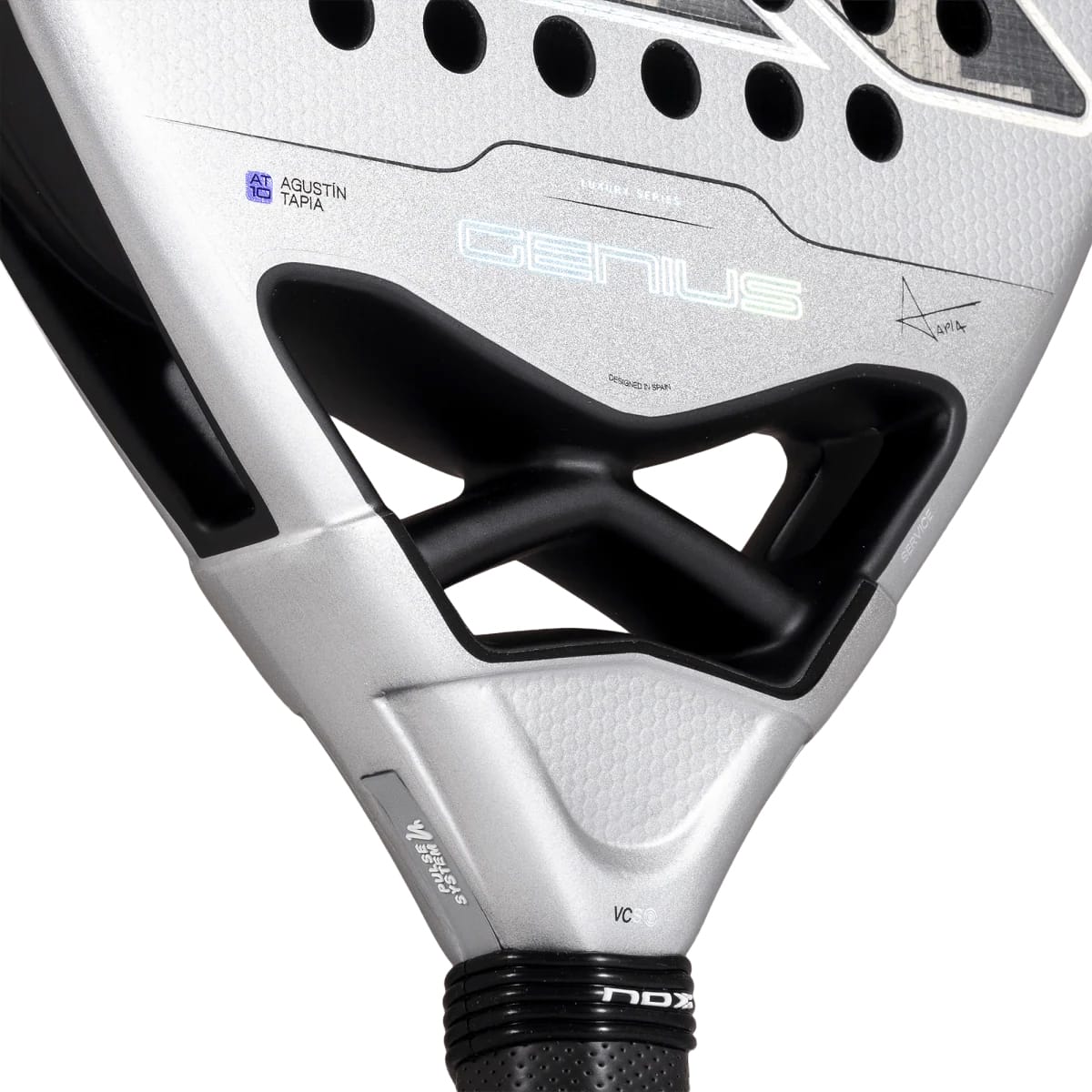 Close-up of the handle and bridge of a silver and black NOX AT10 Genius Attack 12K Alum Xtrem By Agustín Tapia 2027 padel racket, featuring Agustín Tapia’s signature on the face.