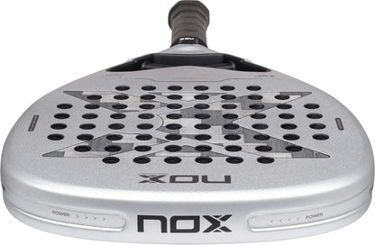 Silver NOX AT10 Genius Attack 12K Alum Xtrem By Agustín Tapia 2027 padel racket with a diamond-shaped head, a black grip, and a geometric pattern over the perforated face.