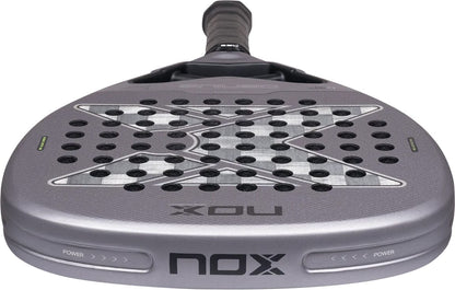 Grey teardrop-shaped NOX AT10 Genius Attack 18K Alum By Agustín Tapia 2027 padel racket with a checkered pattern, perforated surface, and black handle.