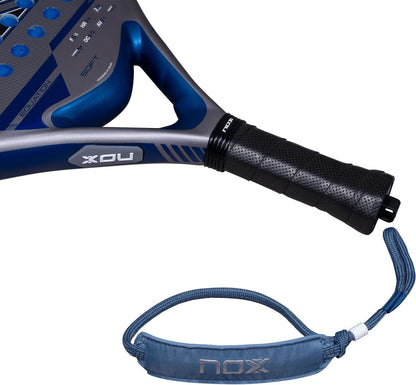 Blue and grey NOX Equation Soft Advanced 2027 padel racket with a perforated black grip and a detachable blue wrist strap.