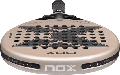 A beige and black NOX Ventus Hybrid 12K Lite 2027 padel racket featuring a teardrop-shaped head and a perforated 12K carbon face.