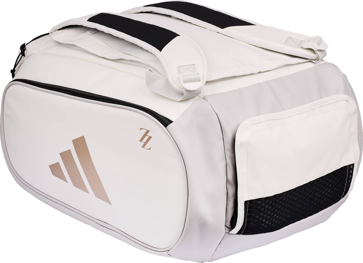 White and light grey ADIDAS Tour ZZ Zinedine Zidane Padel Racket Bag featuring shoulder straps, gold-colored logos on the side, and a mesh pocket.