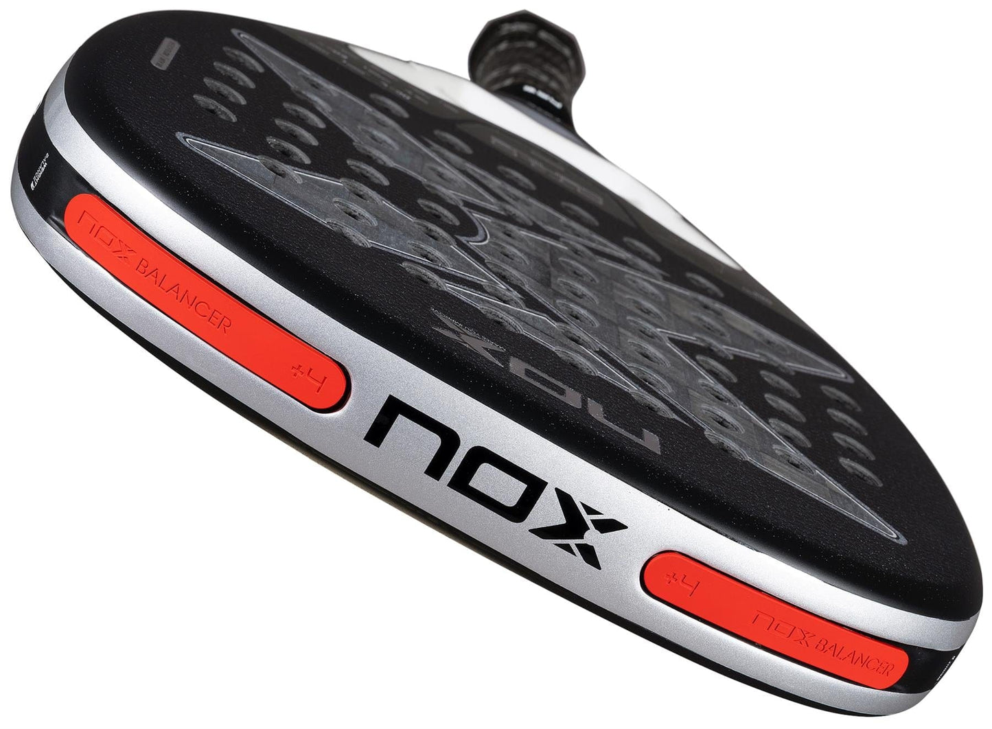 Close-up of the NOX Luxury AT10 Genius Attack 18K Alum By Agustin Tapia 2026 Padel Racket, showing its black 18K aluminised carbon surface with perforations, silver edges, orange "NOX BALANCER #4" labels, and signature patterned design.