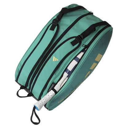The ADIDAS Control 3.4 Padel Racket Bag in green, featuring a gold logo and text, includes multiple black zippered compartments. A tennis racket with a white handle is partially visible inside, enhancing your style on the court effortlessly.