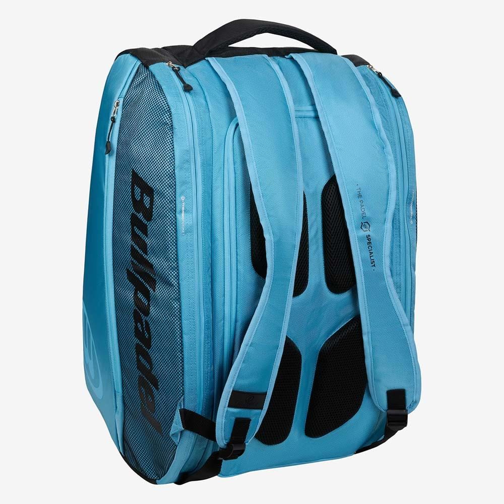 The Bullpadel BPP26003 Vertex W Padel Bag in light blue features mesh pockets, black accents, padded shoulder straps, and a top handle—perfect for carrying your padel equipment in style.