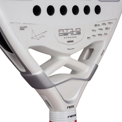 Close-up of the NOX AT10 Genius Attack 12K Alum Extrem By Agustín Tapia 2026 Padel Racket in white with black accents, featuring Agustín Tapia's signature and designed for powerful play.