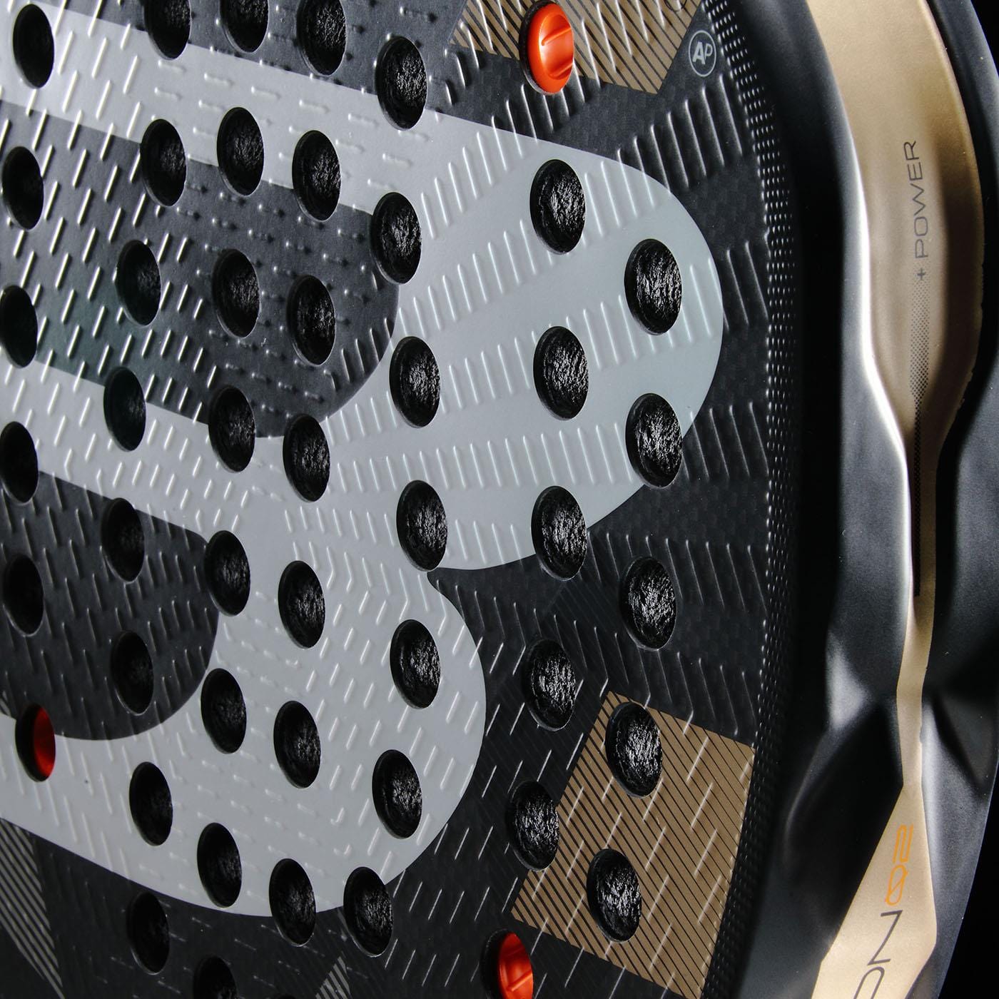 Close-up of the Bullpadel Neuron 02 2026 Padel Racket in black and gold, highlighting its circular holes, textured face, detailed frame pattern, and logo—designed for professional padel players by Bullpadel.