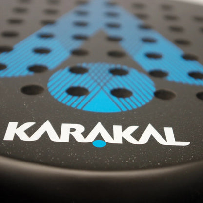 Close-up of the Karakal Air Lite 345 Blue Padel Racket, a lightweight model with blue dotted and striped design, featuring "Karakal" in white letters near the edge.