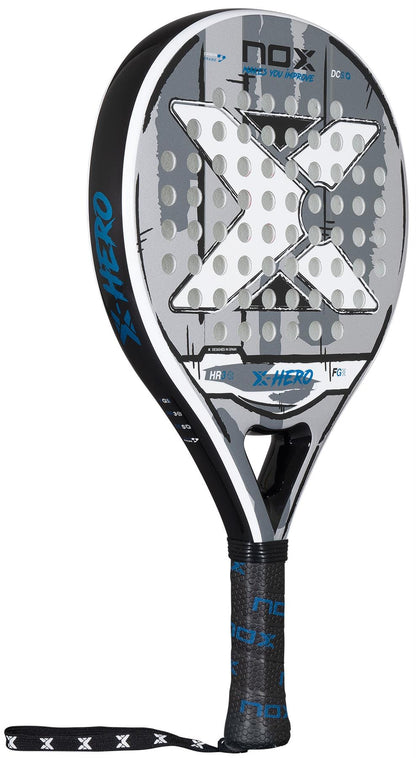 The NOX X-Hero White Padel Racket features a striking large white X on the face, blue accents, a black grip with "NOX" branding, and a wrist strap—perfect for beginners.