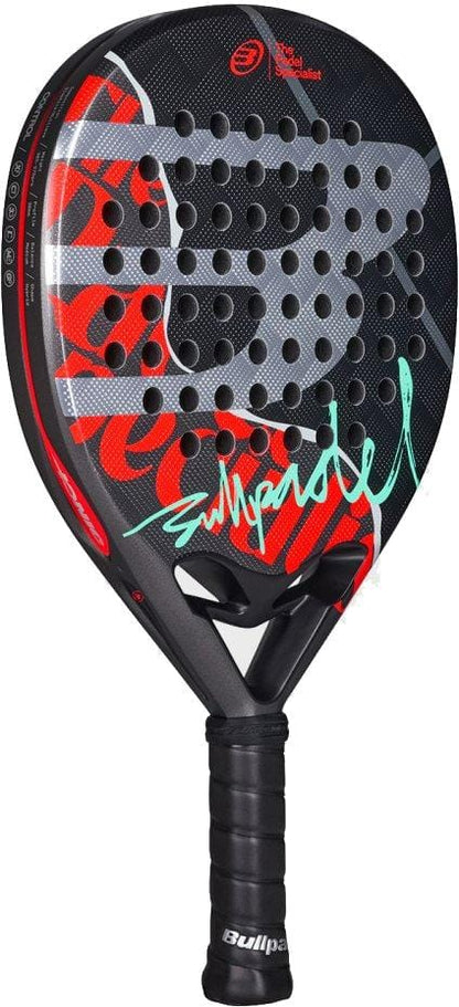 The Bullpadel Ionic Control 2026 Padel Racket by Bullpadel features a black frame with red, white, and turquoise graphics, perforated face, and black handle—ideal for players seeking superior control and precision on court.