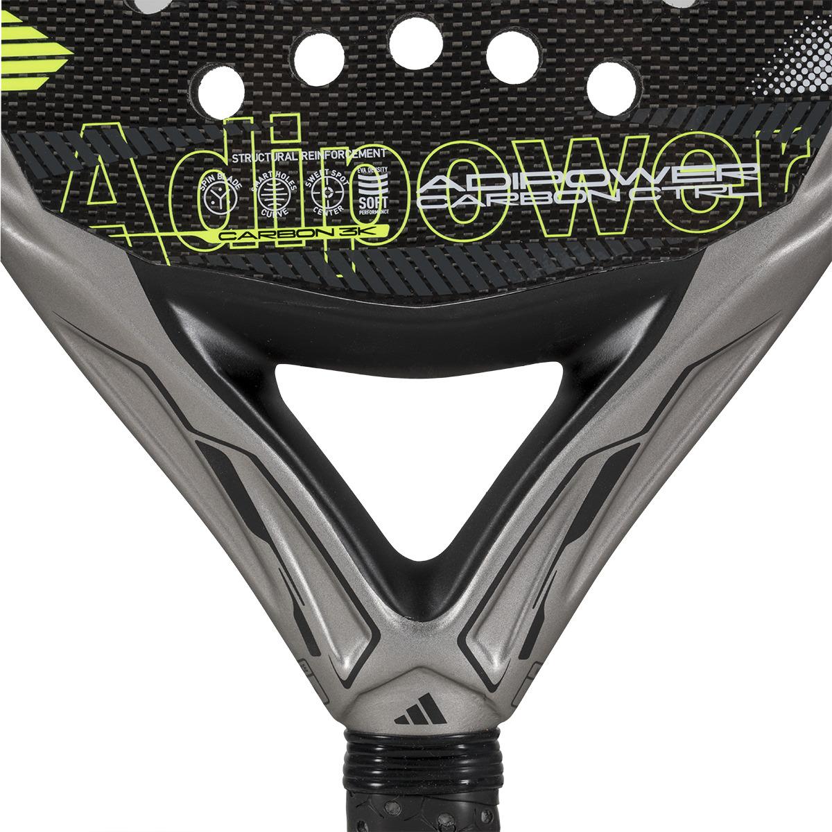 The ADIDAS Adipower Carbon CTRL 3.4 Padel Racket in black and gray features "Adipower" boldly in yellow and white. Its Spin Blade Mold enhances the face, while a triangular patterned grip accents the handle's base.