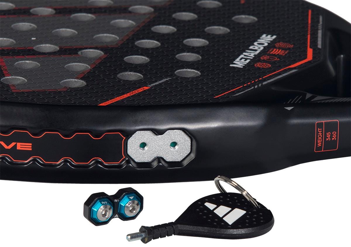 Close-up of the adidas Metalbone by Ale Galán 2026 Padel Racket in black, an adjustable-weight padel racket featuring two hexagonal weights with blue rings and a branded black keychain tool.