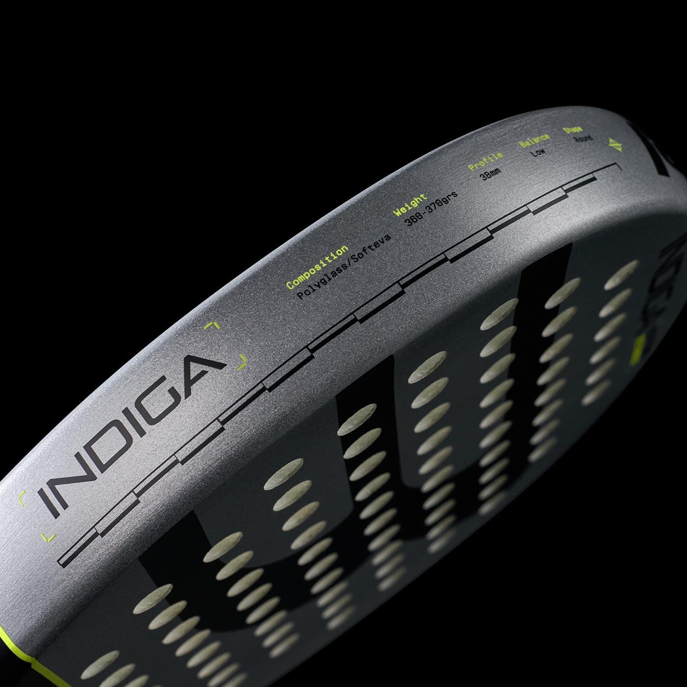 Close-up of the Bullpadel Indiga Ctr 2026 padel racket’s gray edge labeled "INDIGA," showing its specs for precision control—composition, weight, and balance—printed on the surface against a black background.