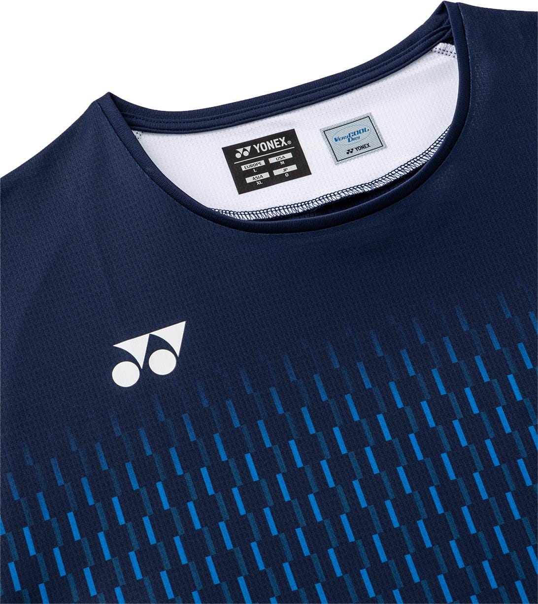 Close-up of the Yonex 10713EX Crew Neck Mens Padel T-Shirt - Dark Navy, a high-performance sportswear piece with blue and dark blue patterned lines. Features the Yonex logo on the left chest and a visible tag inside the collar.