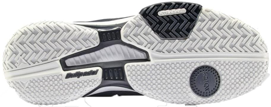 The image shows the outsole of Bullpadel Icon 26V Mens Padel Shoes - Navy, featuring lightweight herringbone and dotted grip patterns in white and black rubber, textured sections for traction, and Bullpadel branding—ideal for padel courts.