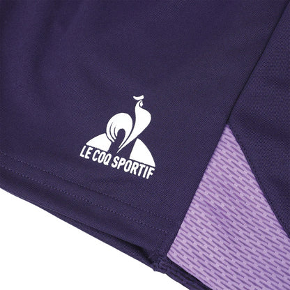 Close-up of the deep purple velvet fabric adorned with a white "Le Coq Sportif" logo depicting a stylized rooster. Featured in the Le Coq Sportif Pro Mens Padel Shorts - Purple Velvet, this design highlights breathable material and includes a lighter purple textured panel along the edge, ideal for tennis players.