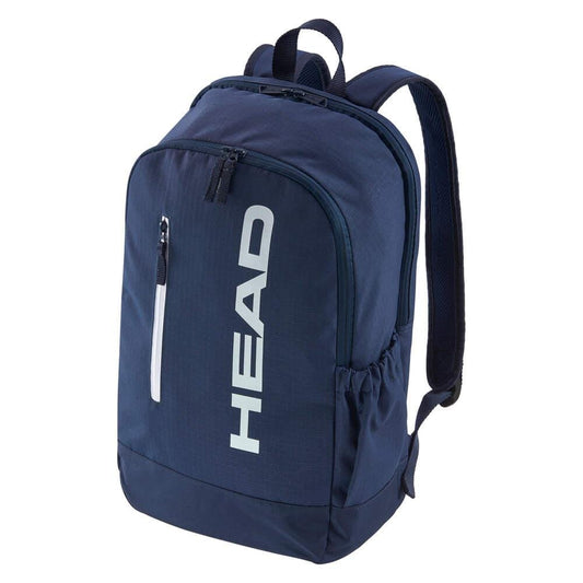 The HEAD BASE Padel Backpack 17L - Navy features a new design with a large front pocket, vertical zip pocket, two side pockets, adjustable padded straps, and a dedicated racket compartment. "HEAD" is printed vertically in white on the front.
