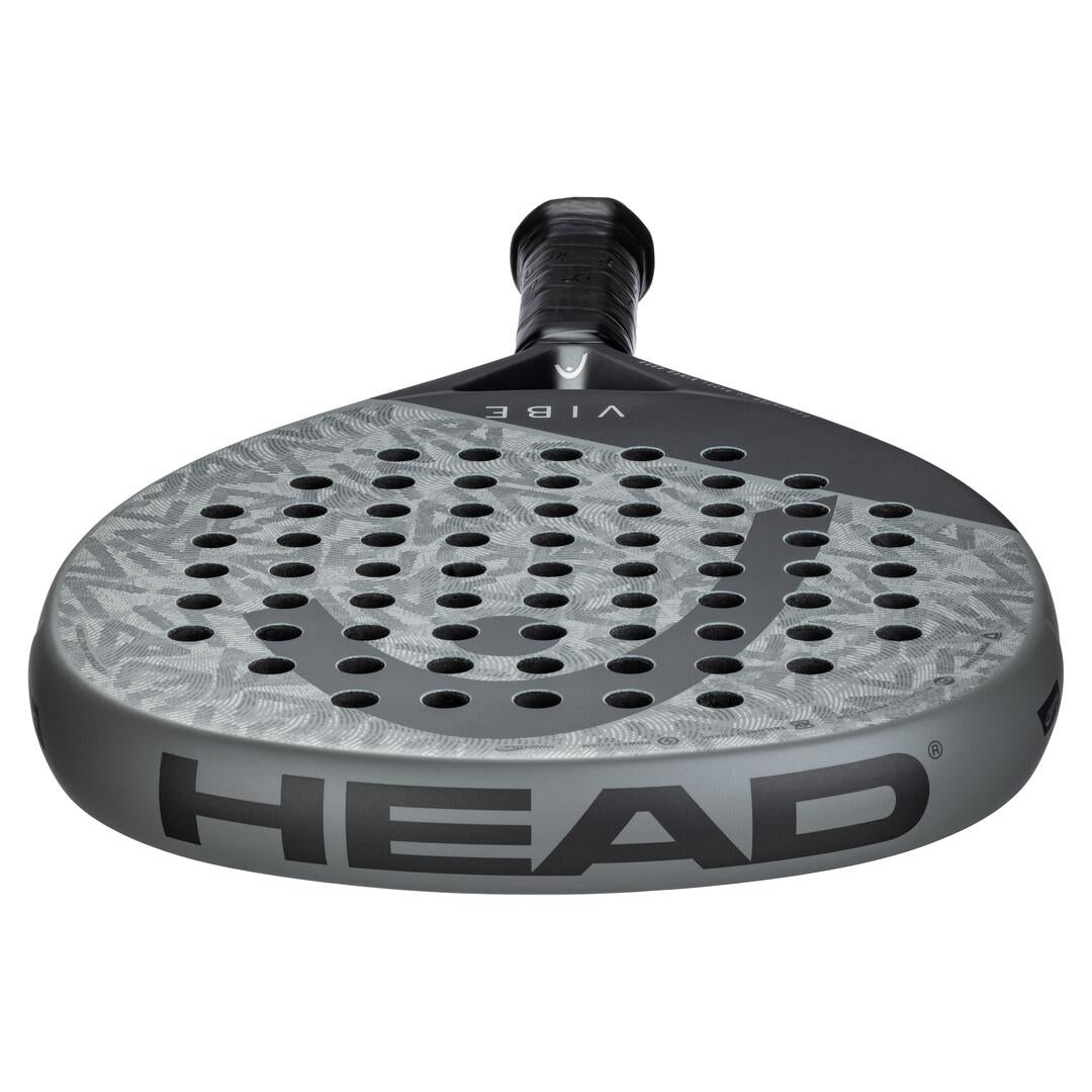 The HEAD Vibe 2025 Padel Racket features an oversized teardrop shape with a sleek grey and black design. Its surface includes a hole pattern and texture, while "HEAD" is prominently displayed on the side for unmistakable brand recognition.