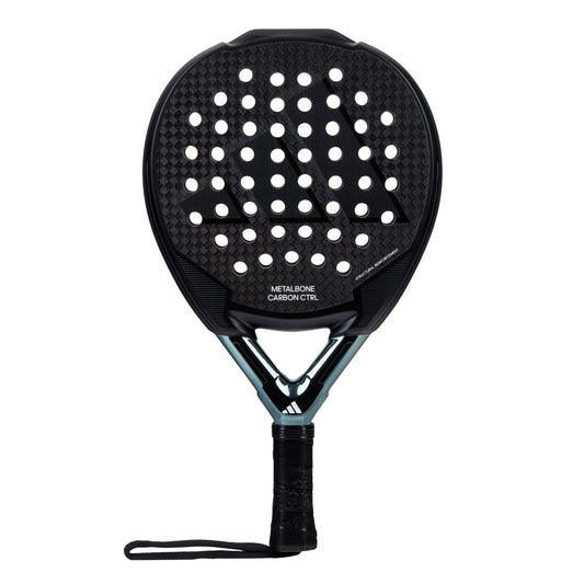 An ADIDAS Metalbone Carbon CTLR 3.3 Padel Racket in black, featuring a perforated teardrop-shaped head with a textured Metalbone Carbon finish. The handle is equipped with a wrapped grip and wrist strap for added comfort, adorned with various adidas brand markings and a Spin Blade decal on the surface.