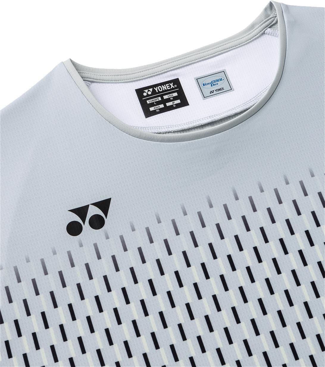 Close-up of the light silver grey Yonex 10713EX Crew Neck Mens Padel T-Shirt, featuring a black Yonex logo on the chest, a pattern of vertical dark lines, and two labels sewn into the inside collar.